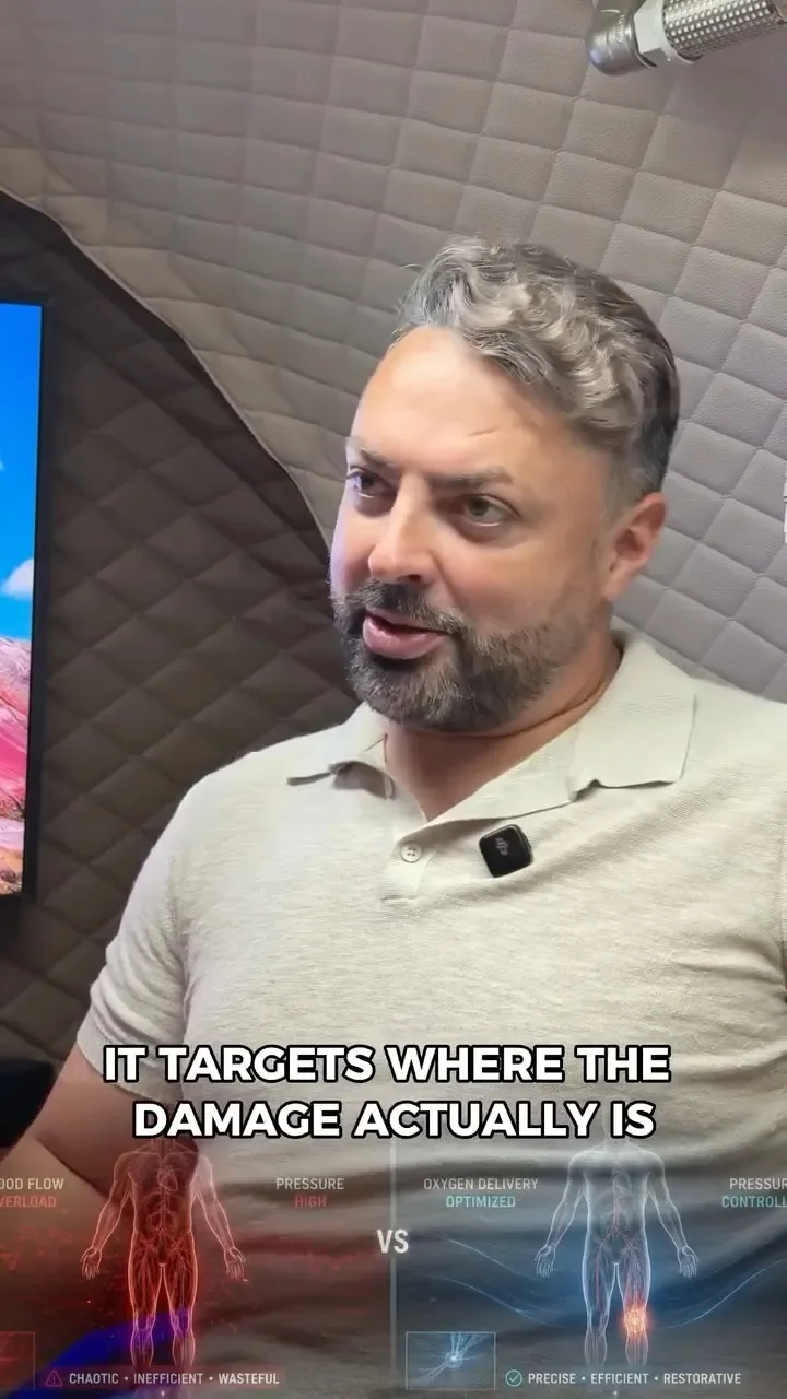 Man in a grey polo shirt speaking inside a quilted hyperbaric chamber, above a blood flow diagram